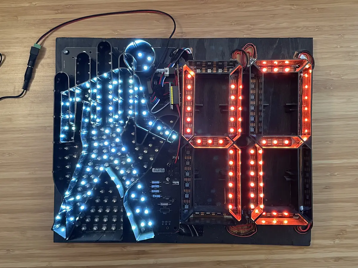 Internals of a pedestrian crossing light, with additional wires and a microcontroller wedges into the extra space.