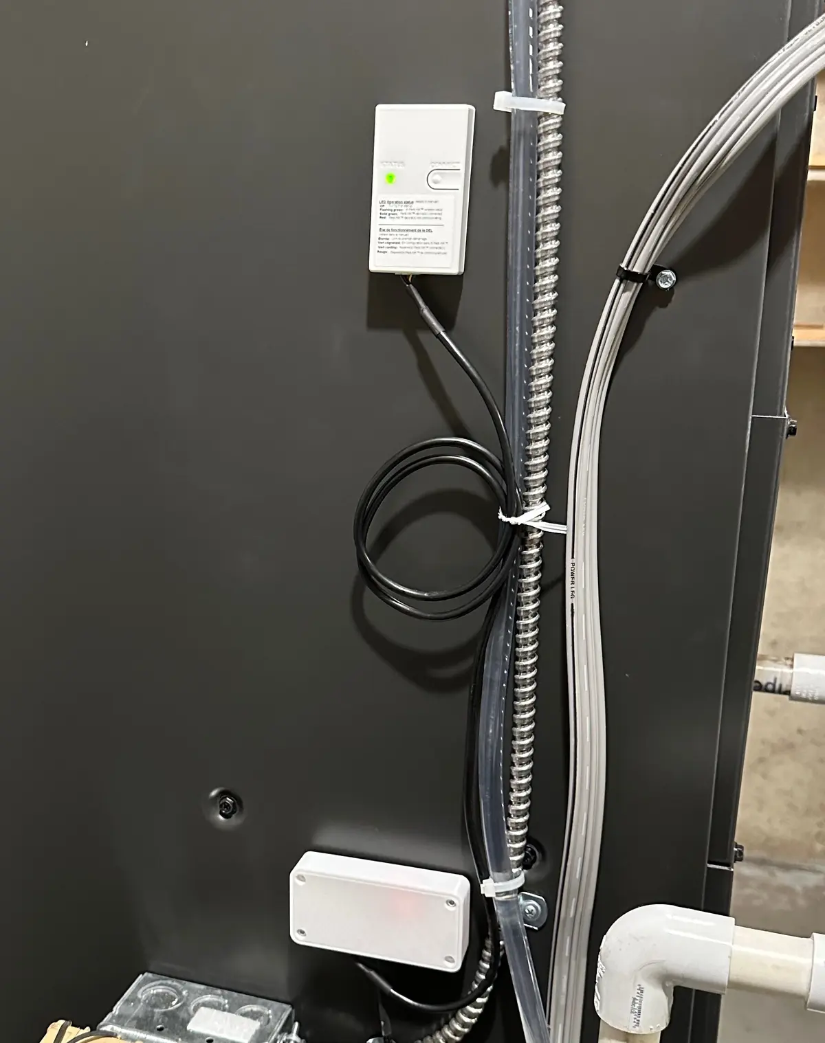 Side of an HVAC air handler with the new enclosure mounted